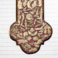 Decorative Milagros wood cross with many charms “miracles” on a white brick wall background Bottom 