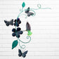 Decorative metal wall art with butterflies and flowers on a white brick wall background back