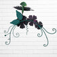 Decorative wall art with three orange flowers and hummingbird on a white brick wall background back view.
