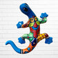 Colorful ceramic lizard wall art against a white brick wall background
