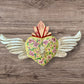 Milagros decorated sacred heart with wings front