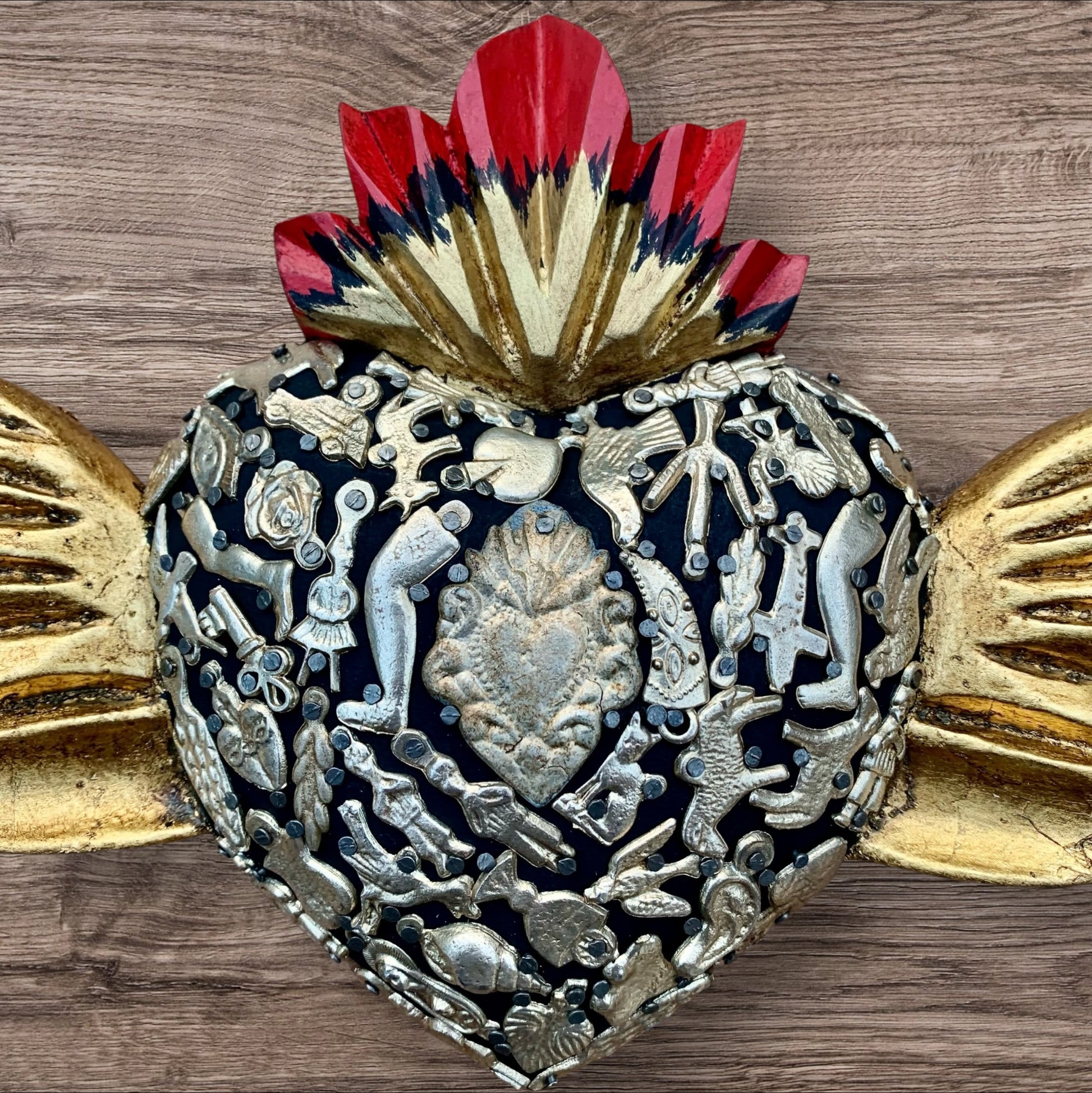 Milagros decorated sacred heart with wings center