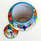 Colorful Mexican Talavera ceramic jar with lid decorated with intricate multicolor traditional patterns Inside viewers 