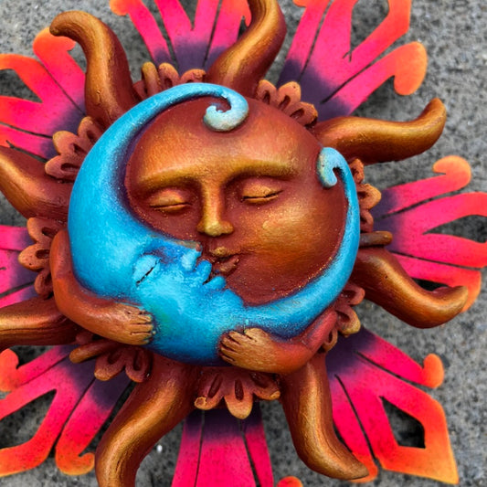 Sun holding blue moon amore close up