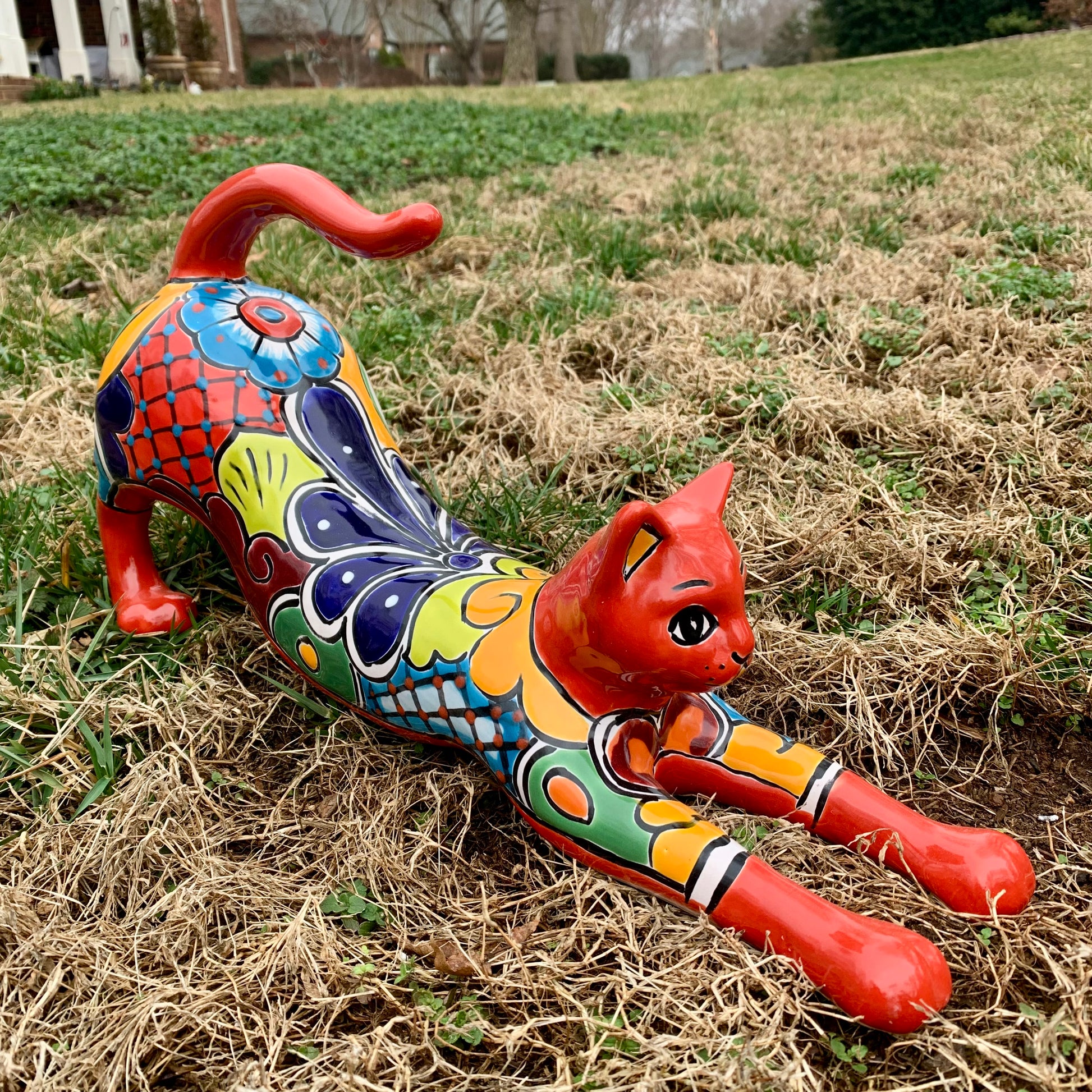Large red stretching kit cat made out of Mexican Talavera