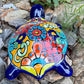 Colorful Mexican Talavera ceramic turtle figurine on a natural stone background Back