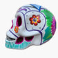 Colorful Mexican Sugar skull white with vibrant designs on a white background side view