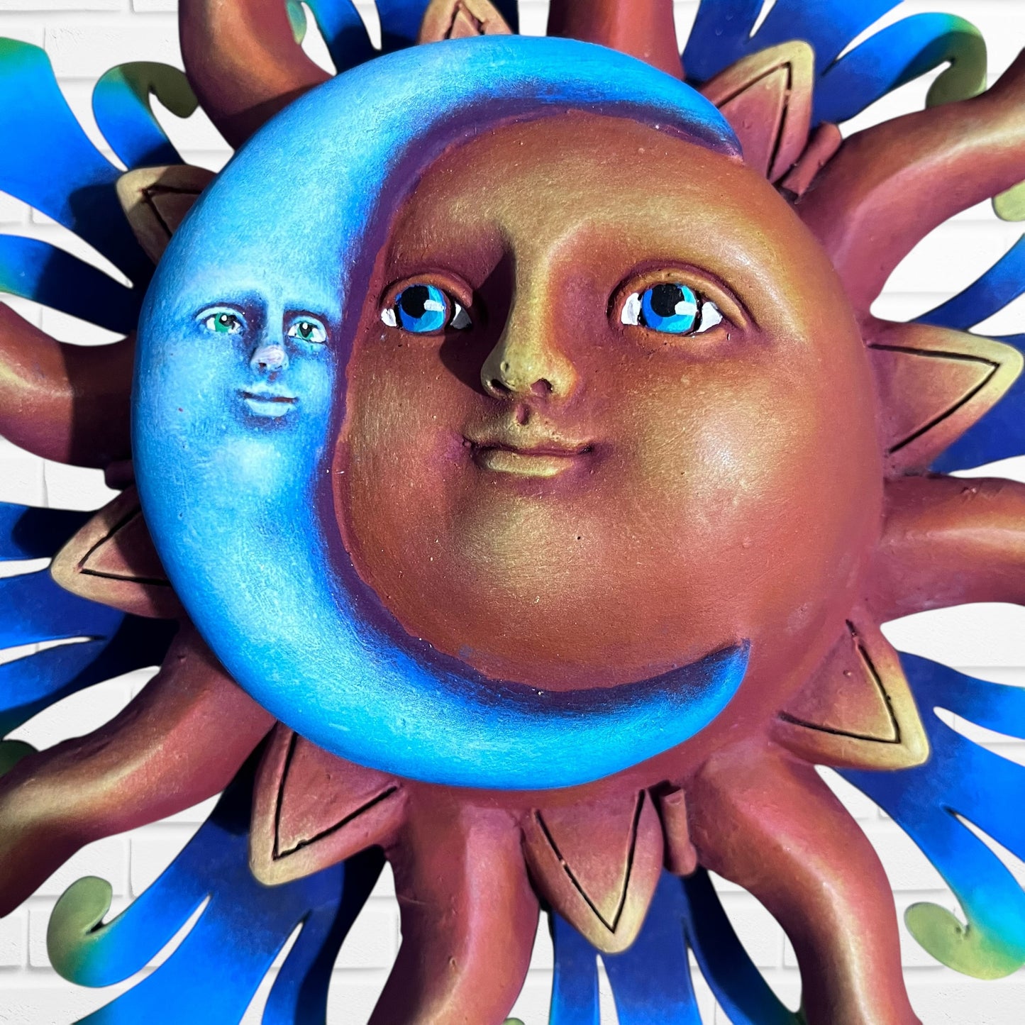 Close-up of sun, face and moon, face, metal sun, wall art