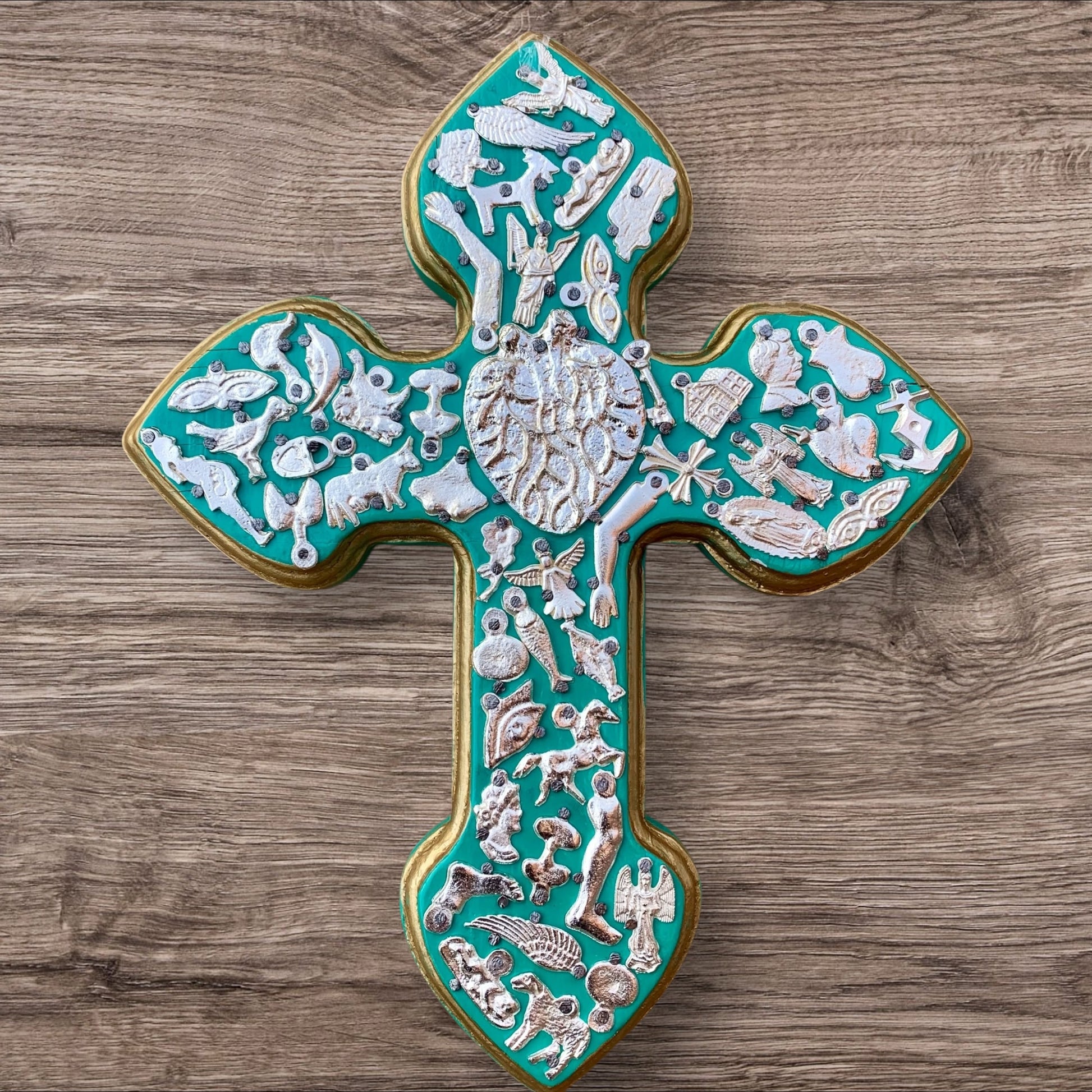 Milagros decorated wood cross blueish green with natural looking heart center