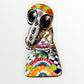 A talavera catrina dog skeleton figurine with colorful hand-painted floral and geometric patterns, standing on a matching decorated base against a plain white background. Front face view.