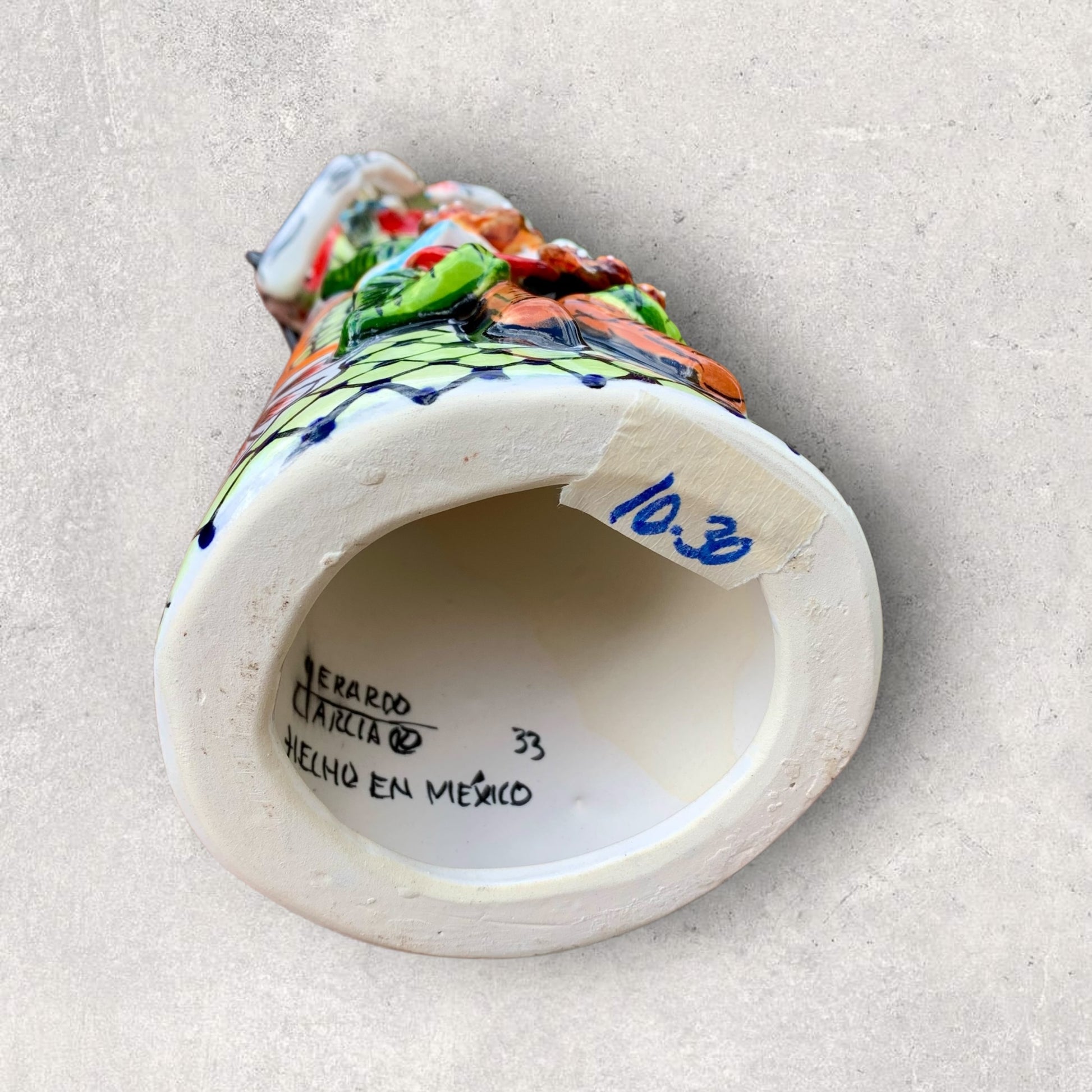 Talavera Frida doll bottom view showing artist signature
