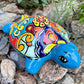 Colorful Mexican Talavera ceramic turtle figurine on a natural stone background 