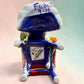 Frida Kahlo Talavera day of the dead figurine sitting in a chair holding a monkey with a parrot on her shoulder. She is painted and bright colors and signed by the artist. Photo of the signature on the bottom of the chair.