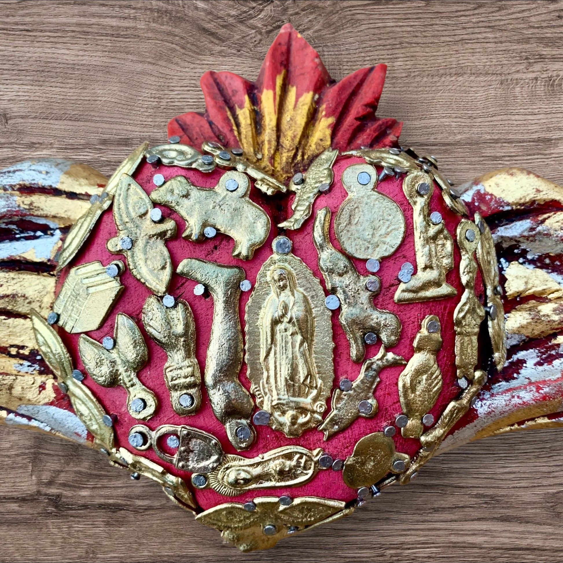 Milagros winged heart with guadalupe in center Close up