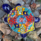 Colorful Mexican Talavera ceramic turtle figurine on a natural stone background Top