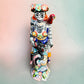 Frida Kahlo Talavera day of the dead figurine sitting in a chair holding a monkey with a parrot on her shoulder, top view looking down on chair.