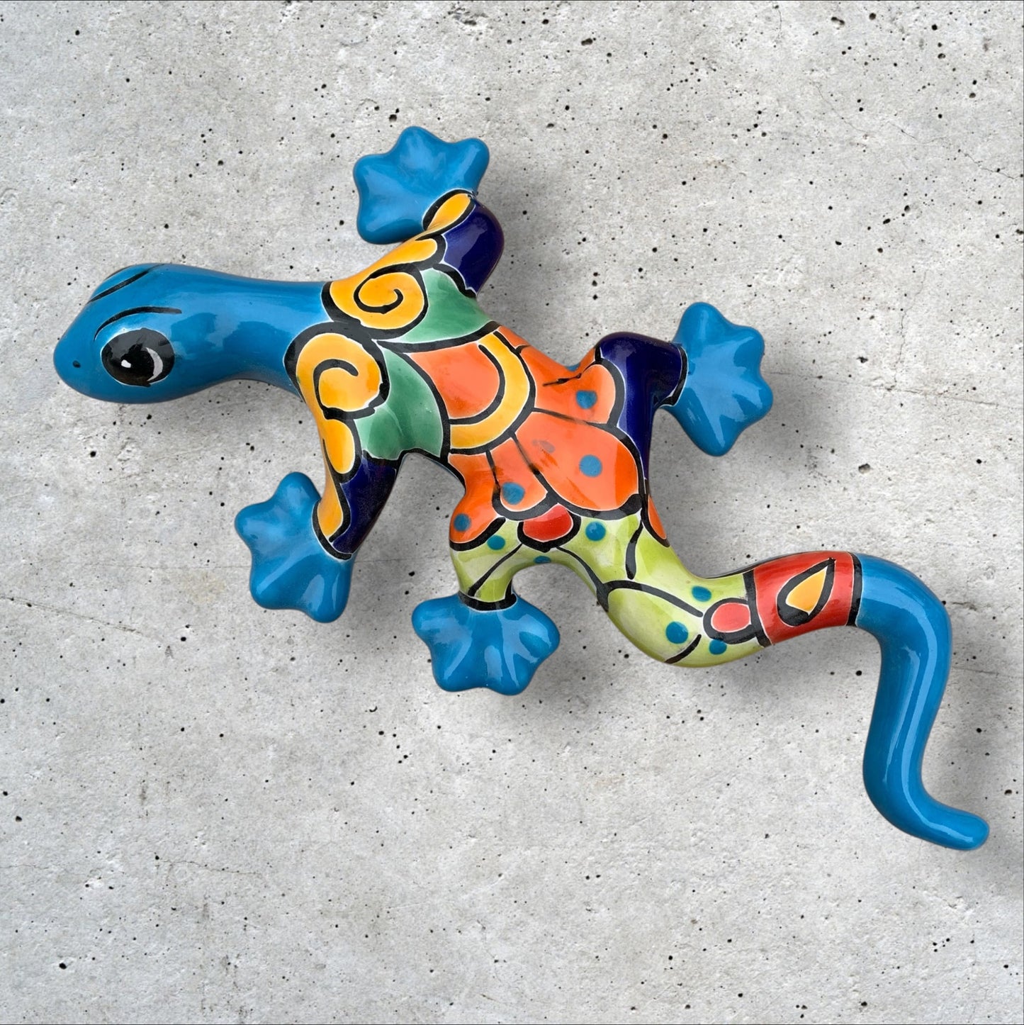 Colorful Mexican Talavera Liizard wall art on a concrete surface Turquoise Gecko One