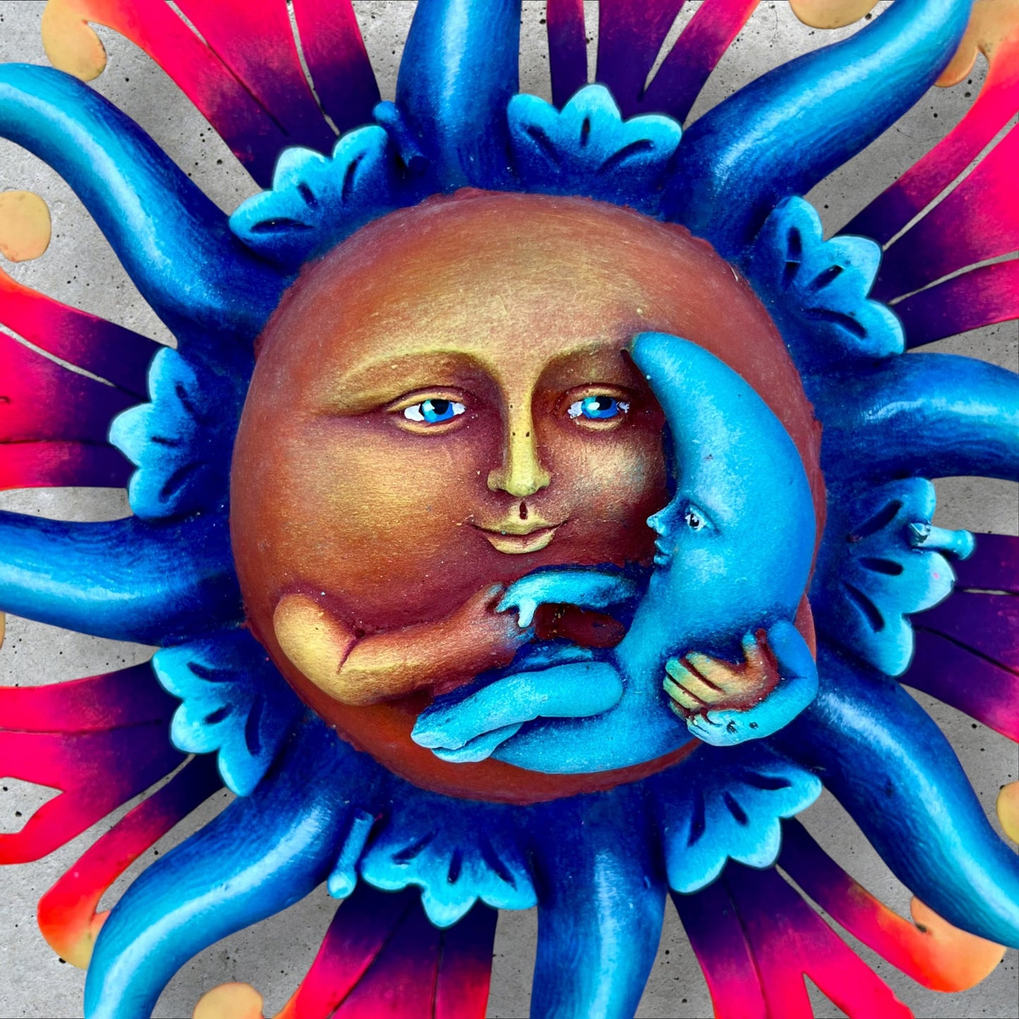 Peaceful sun holding moon face 
