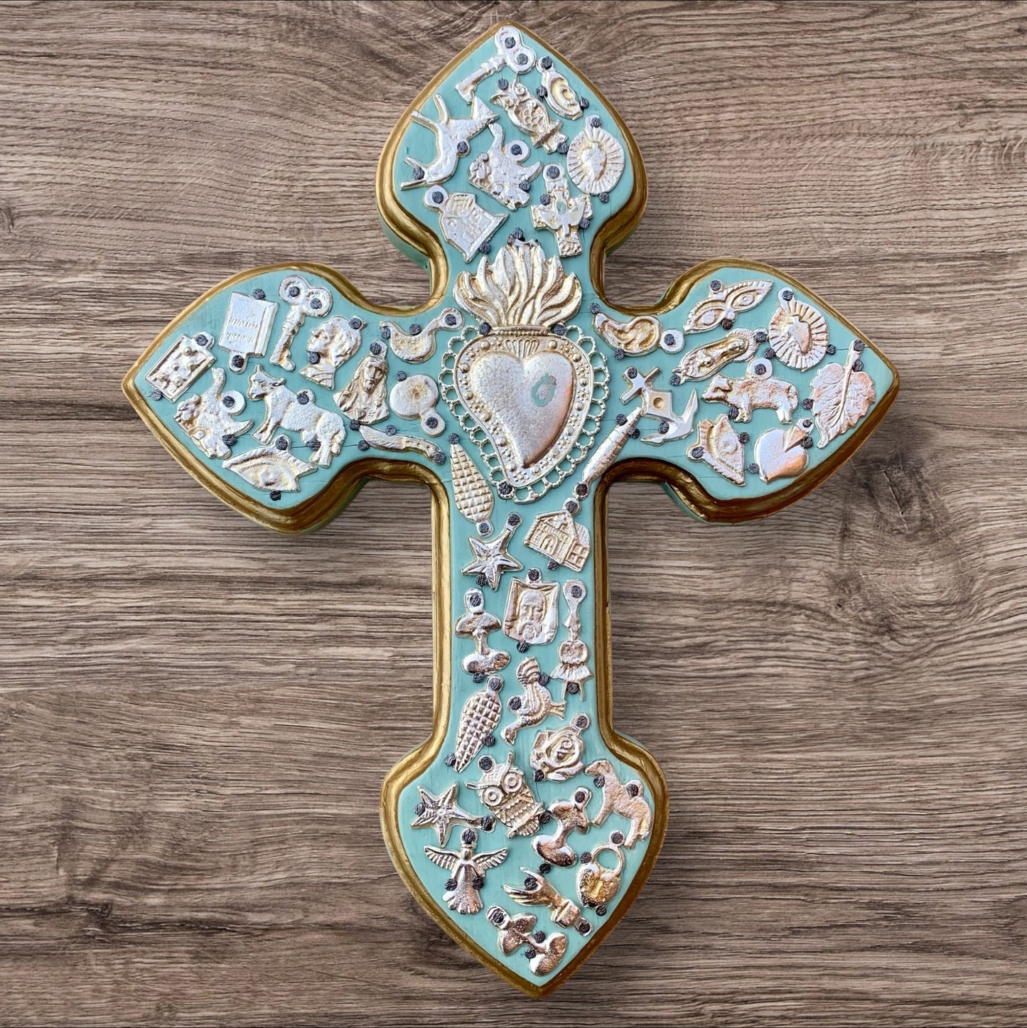 Milagros decorated wood cross teal with flaming heart center