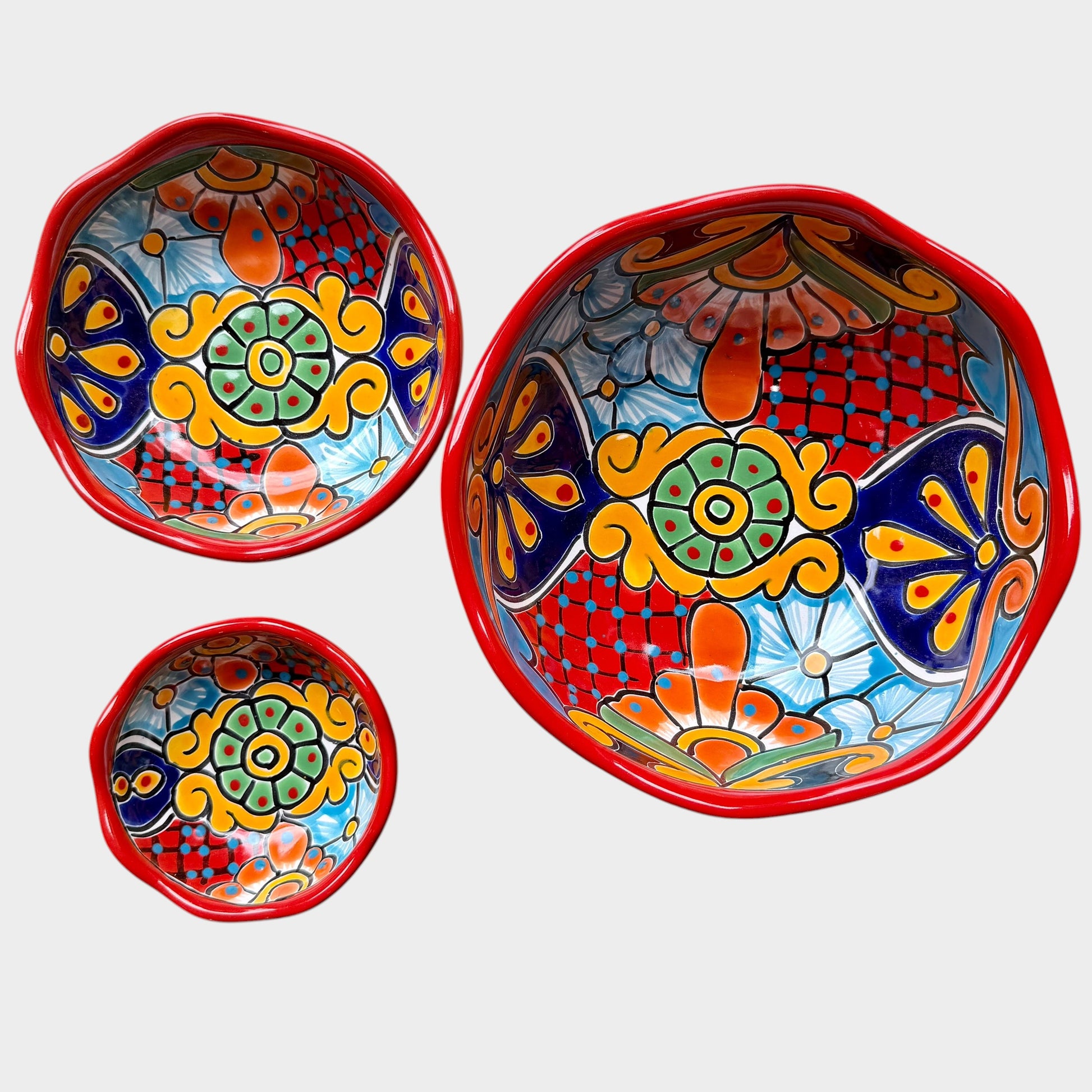 Three colorful talavera nesting bowls with intricate patterns shown unstacked