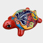 Colorful ceramic turtle figurine on a white background side