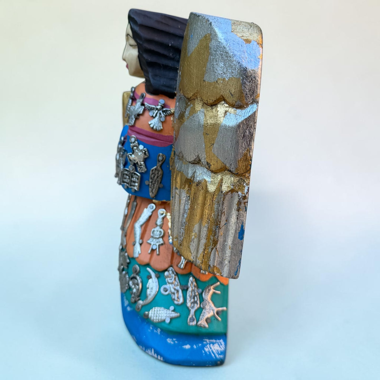 Right side view of Milagros guardian angel figurine.

