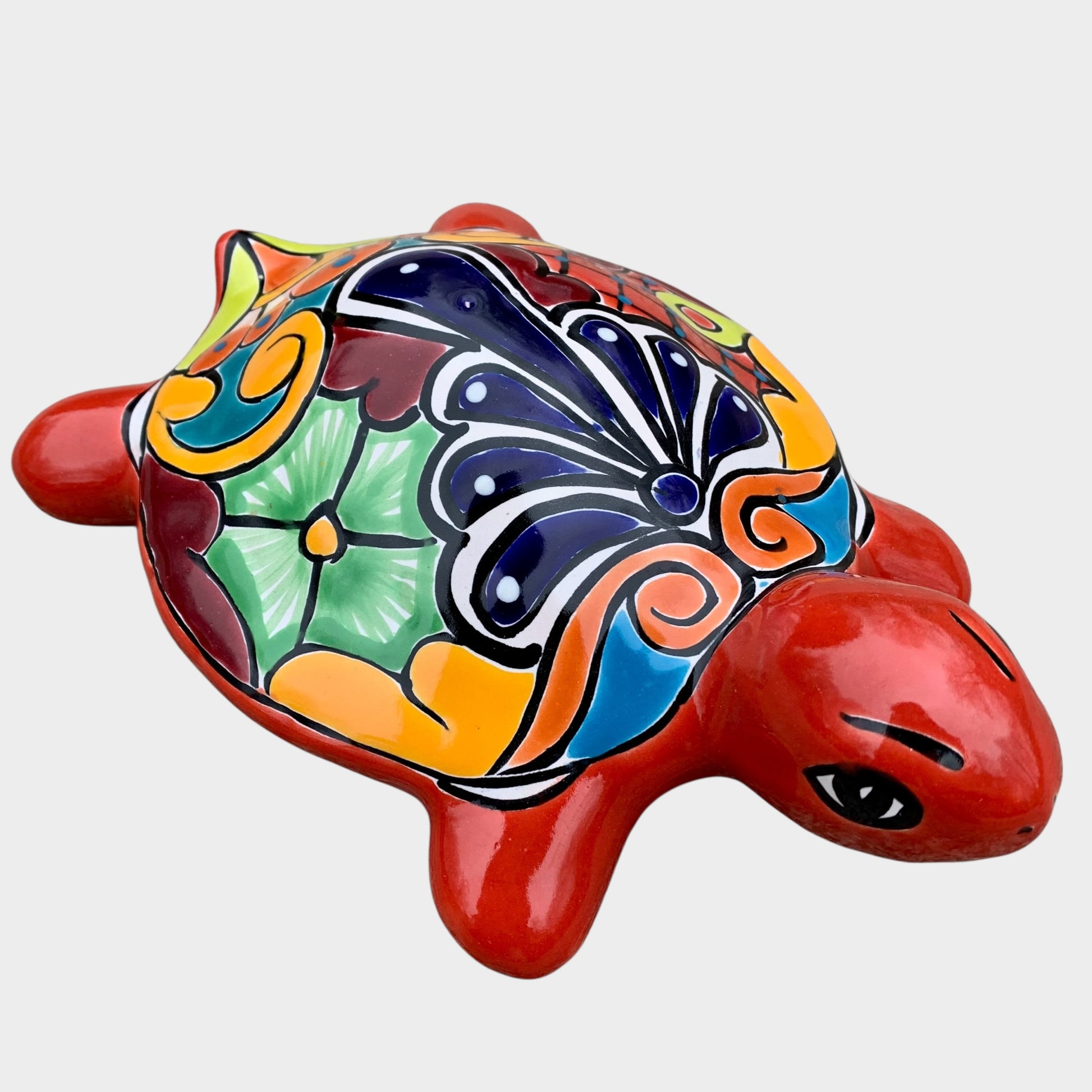 Colorful ceramic turtle figurine on a white background