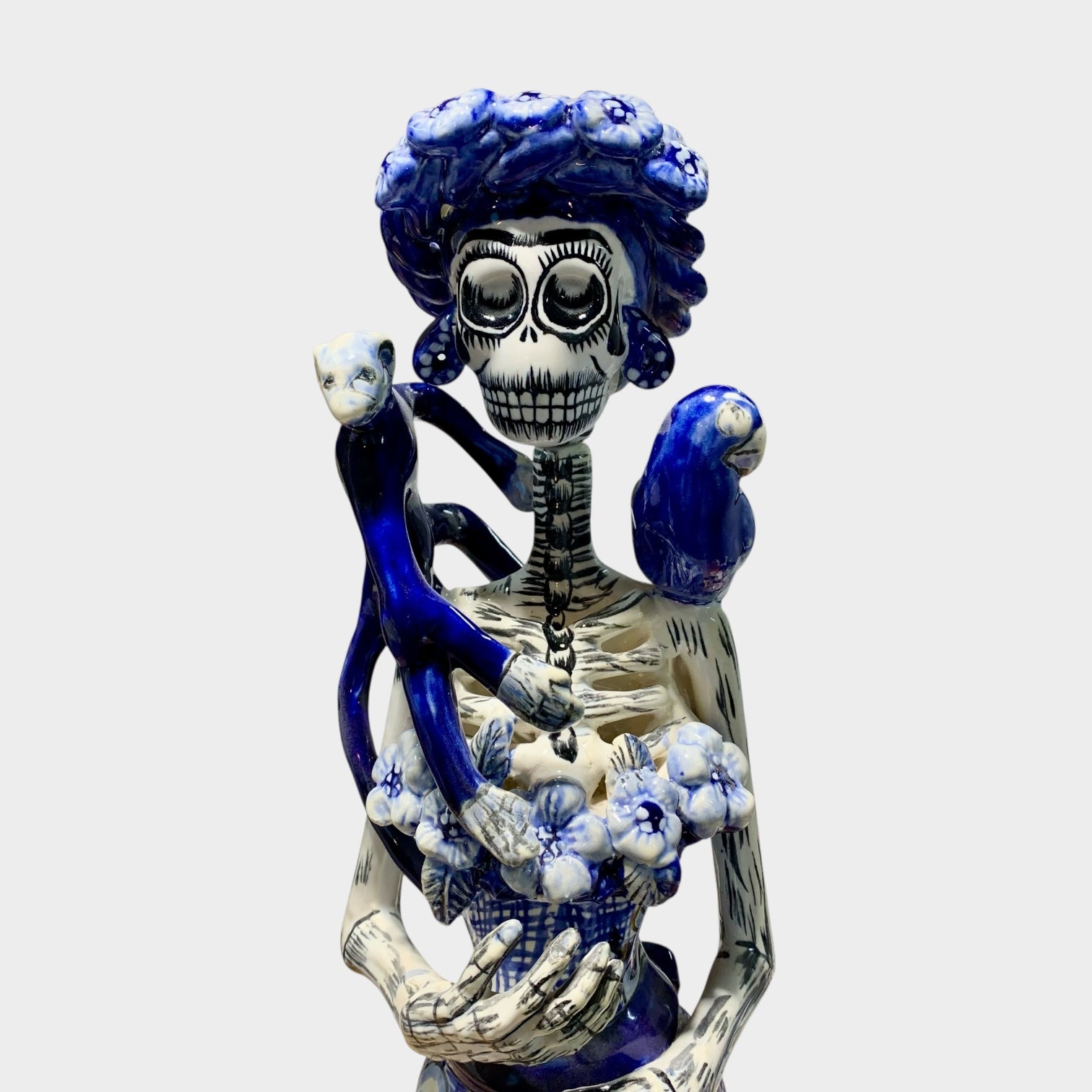 Frida and friends Catrina in classic blue and white. Friends include a monkey and parrot on her shoulders