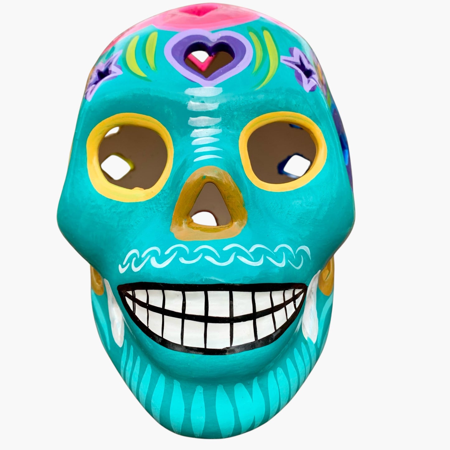 Colorful Mexican Sugar skull teal with vibrant designs on a white background front view 