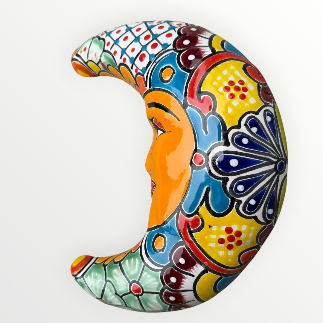 Decorative wall art in the shape of a stylized face on a white background curved side