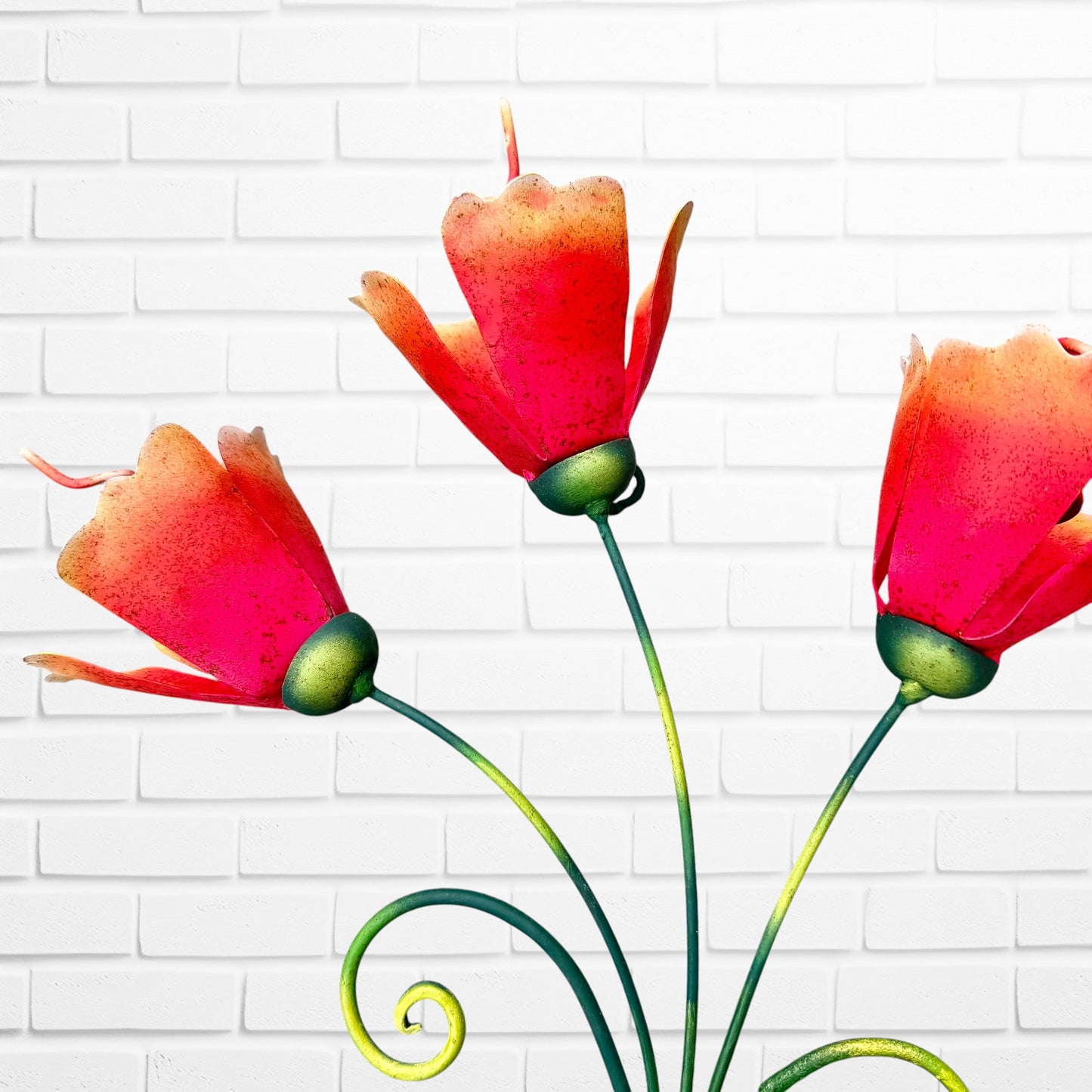 A close-up of the three orange flowers included on the sculpture.
