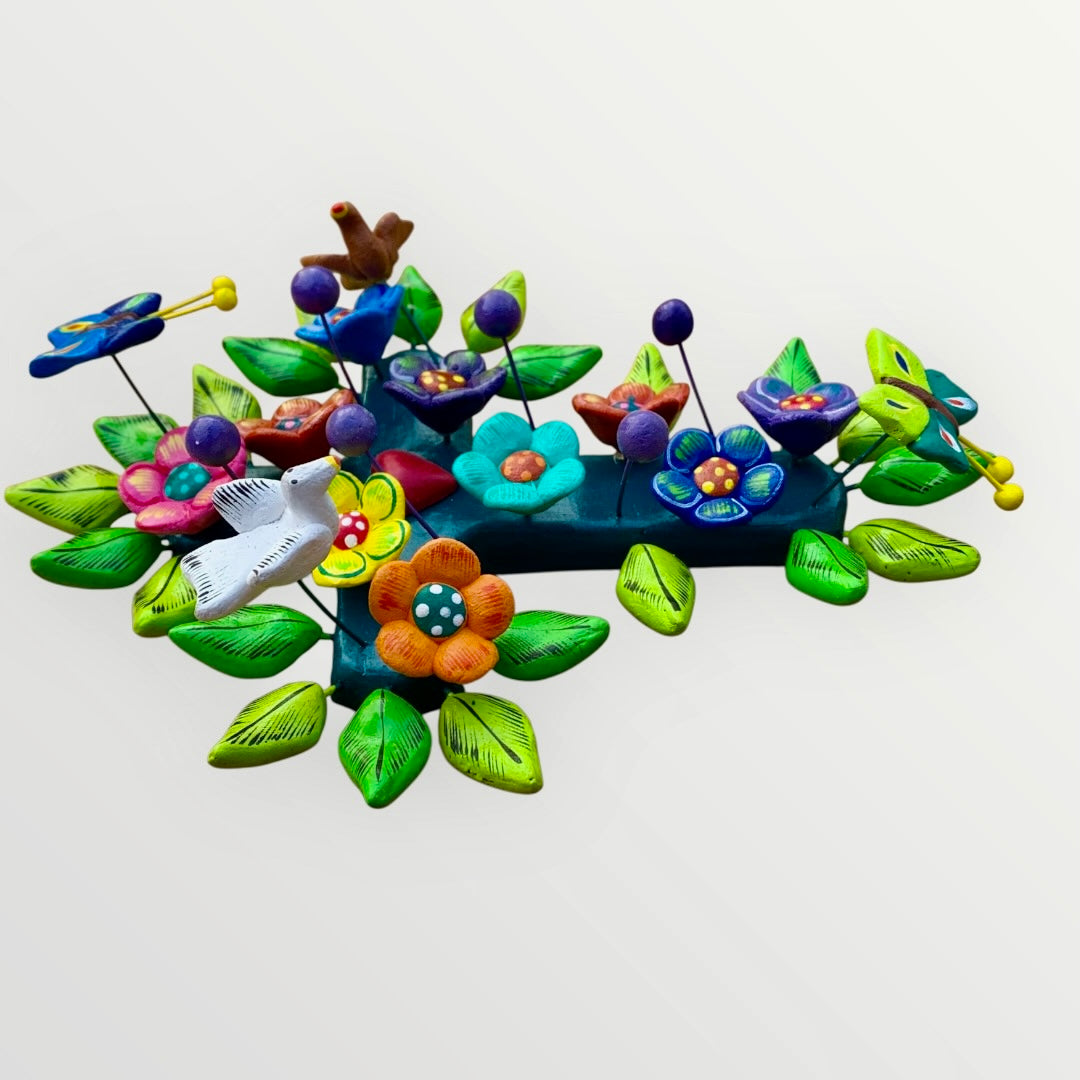Ortega Pottery Folk art cross with leaves, flowers and butterflies three dimensional side view left.