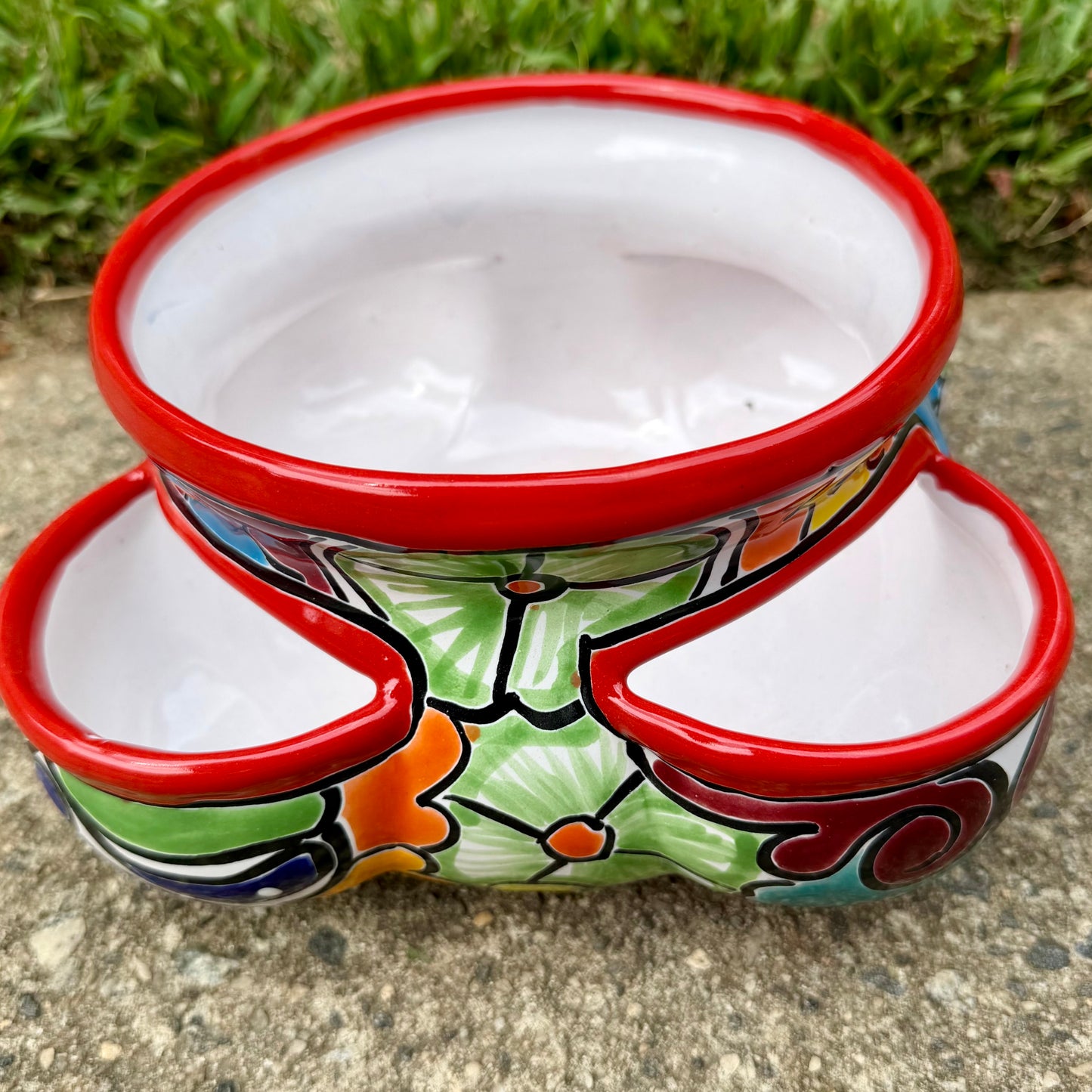 Hand painted Mexican Talavera Strawberry pot with a large top opening a four pockets on each side.  Trim color is bright red, body has multi-color designs. This is the side view.