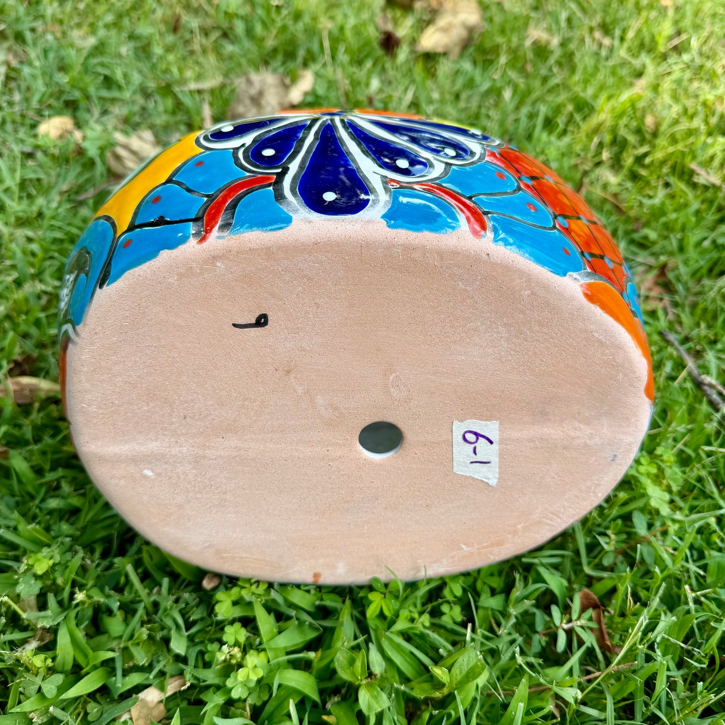 Colorful Mexican Talavera ceramic chicken shape planter on a natural background Bottom drain hole