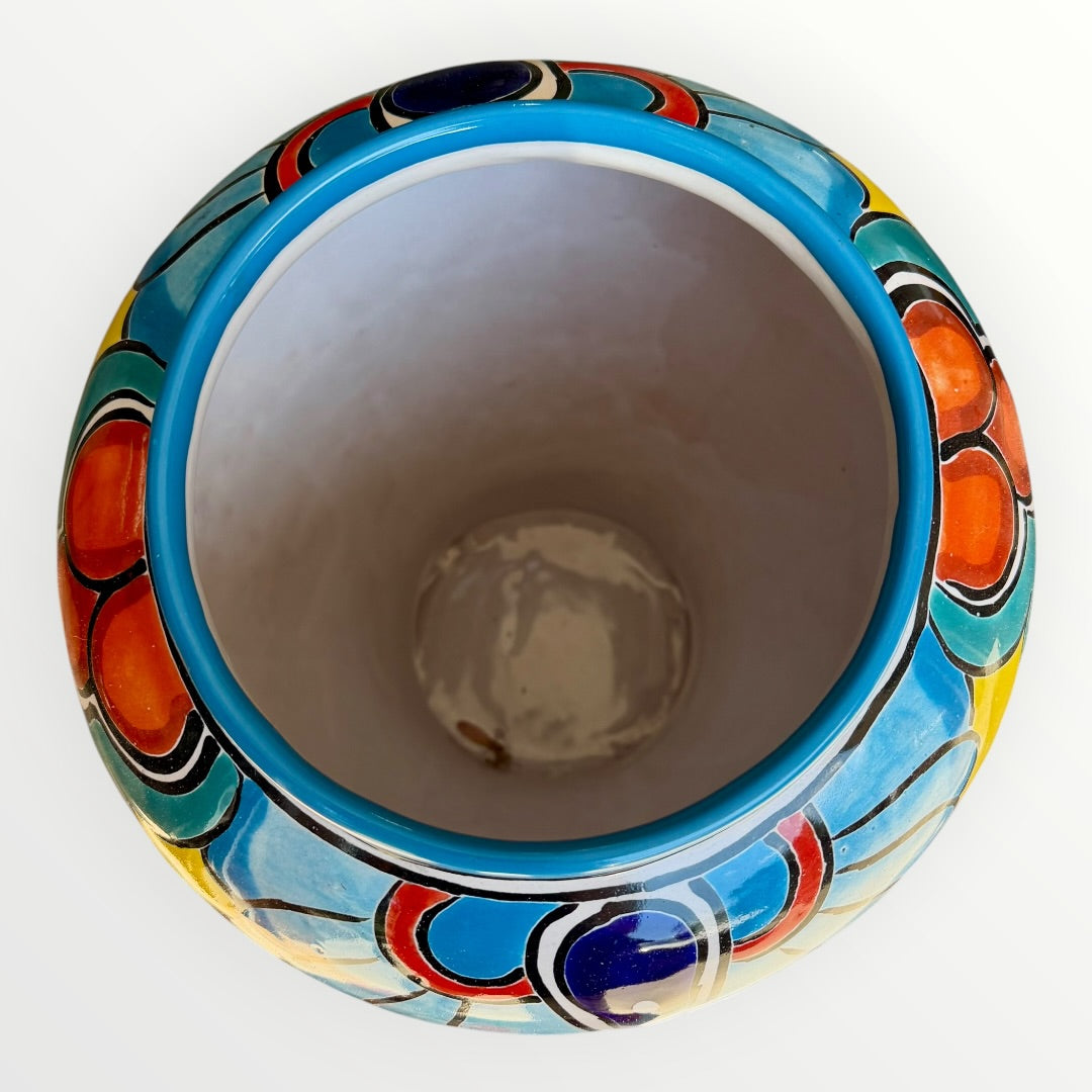 Colorful Mexican Talavera ceramic jar with lid decorated with intricate multicolor traditional patterns Inside