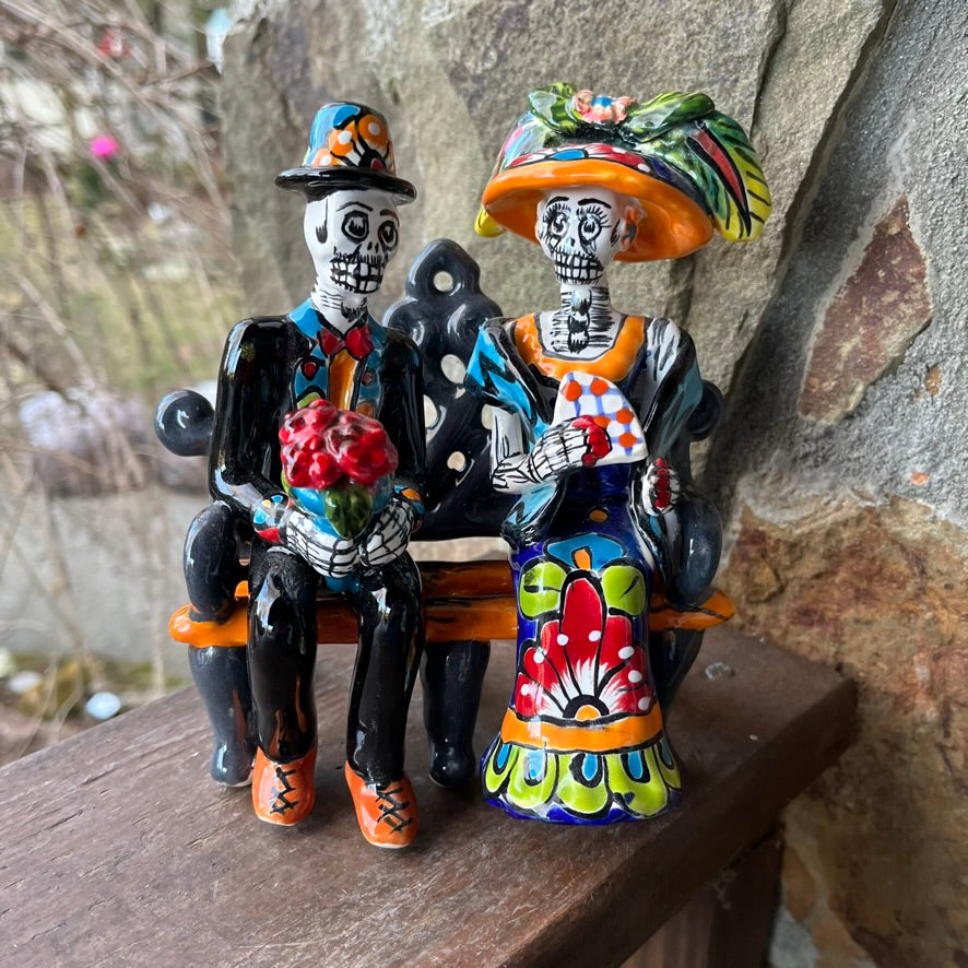 mexican catrina couple on a bench