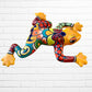 Colorful ceramic frog sculpture on a white brick wall background right side 