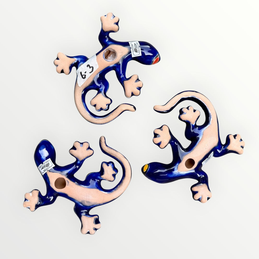 Three colorful ceramic lizards on a white background Back