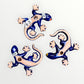 Three colorful ceramic lizards on a white background Back