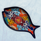 Blue decorative fish-shaped talavera serving plates with colorful hand-painted floral and geometric patterns, displayed on a light blue background.