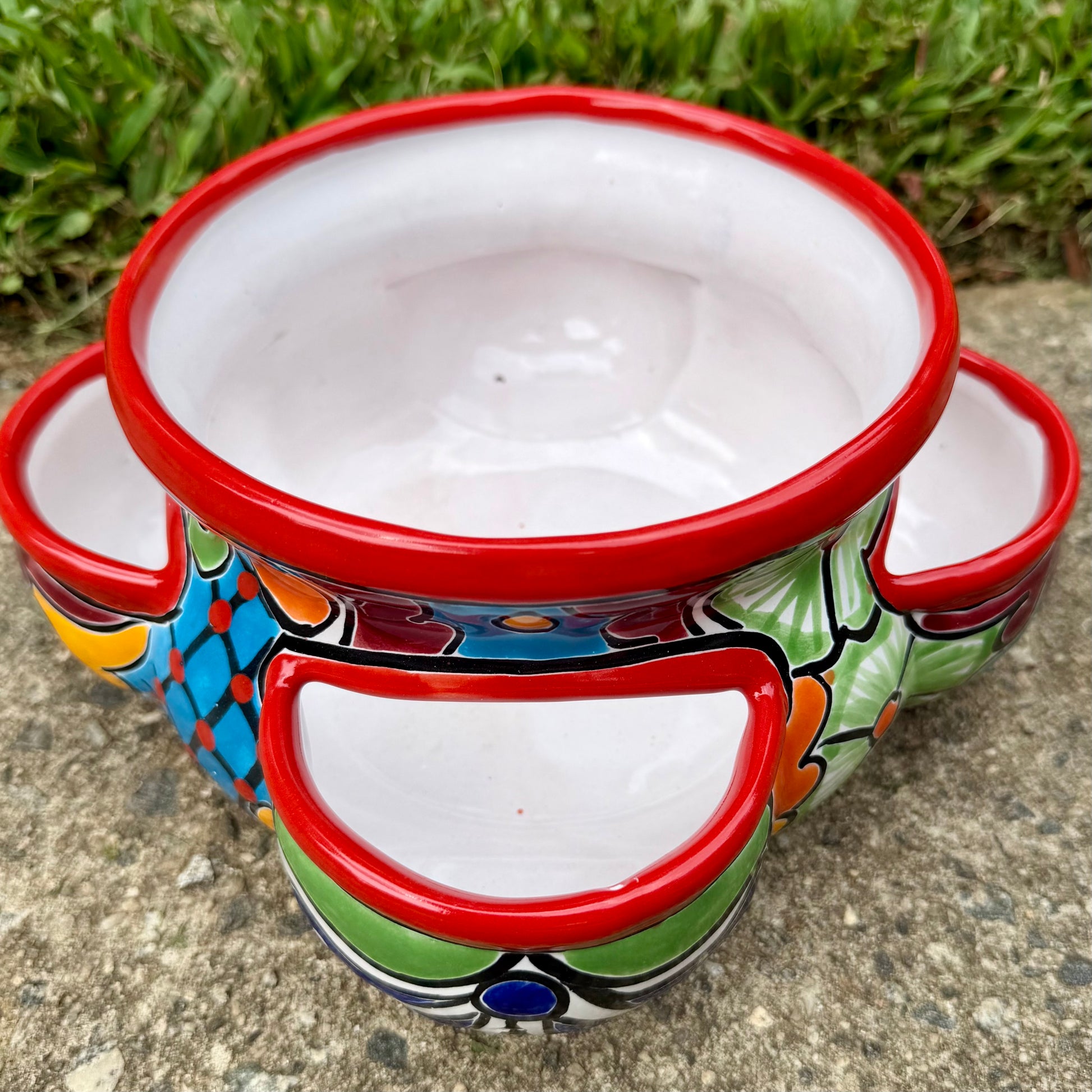 Hand painted Mexican Talavera Strawberry pot with a large top opening a four pockets on each side.  Trim color is bright red, body has multi-color designs.