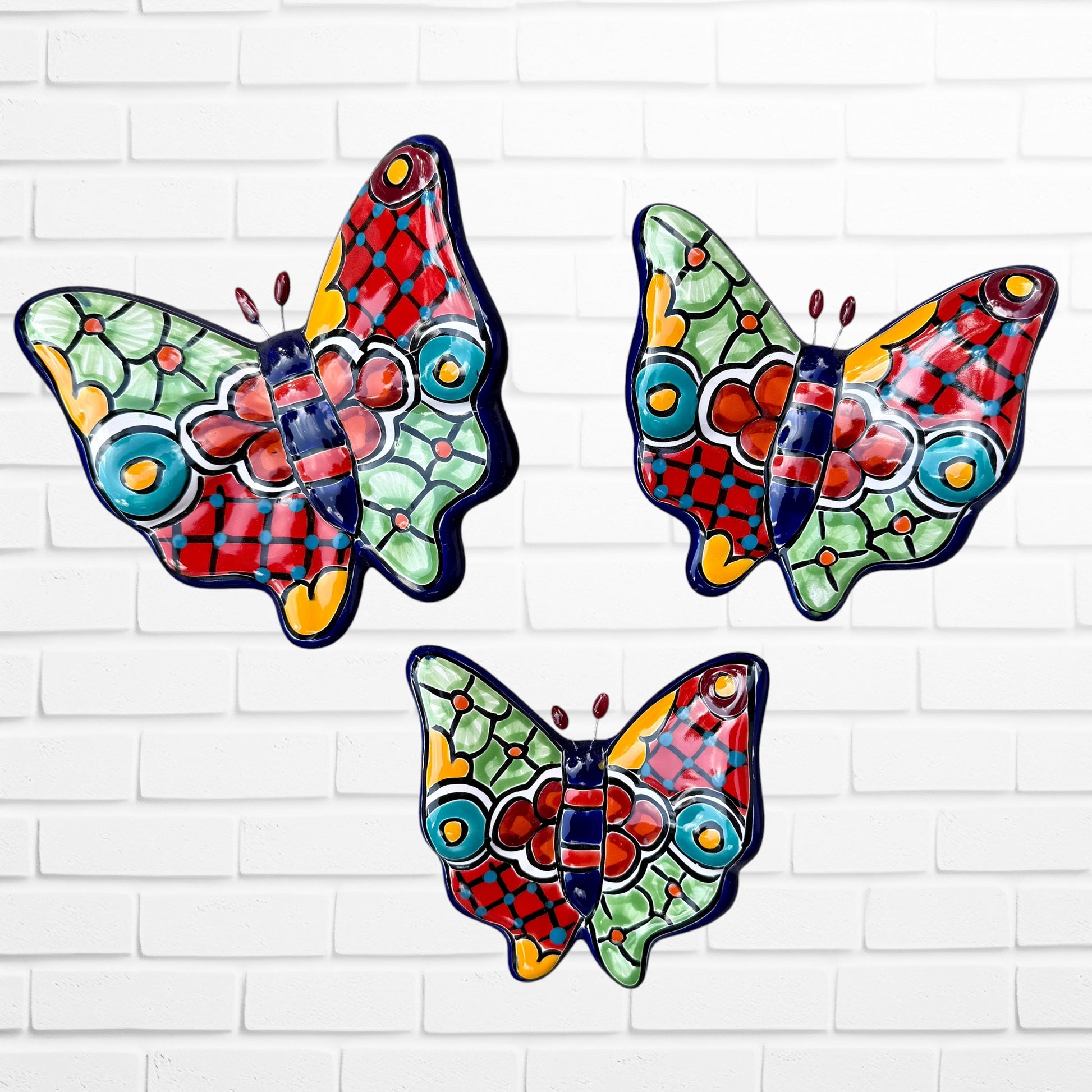 Three colorful talavera butterfly wall art pieces with blue and traditional multicolor patterns, 