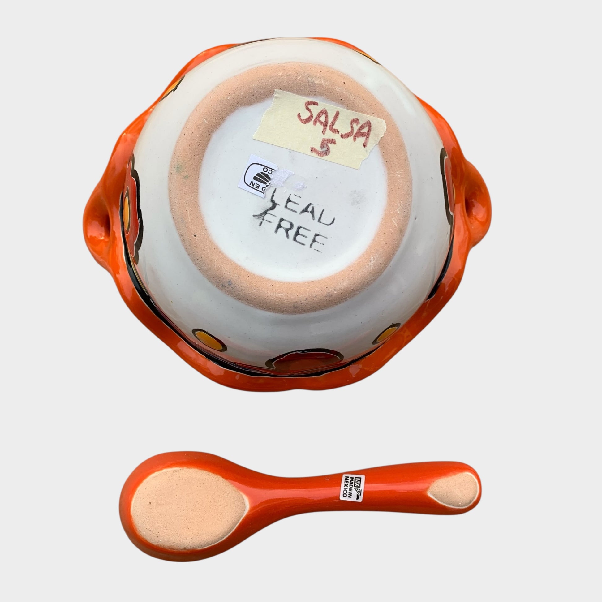 Colorful talavera salsa bowl with floral patterns and spoon on a white background Bottom