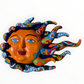 A colorful hand-painted Talavera ceramic sun wall sculpture with big wavy rays on a plain white background.