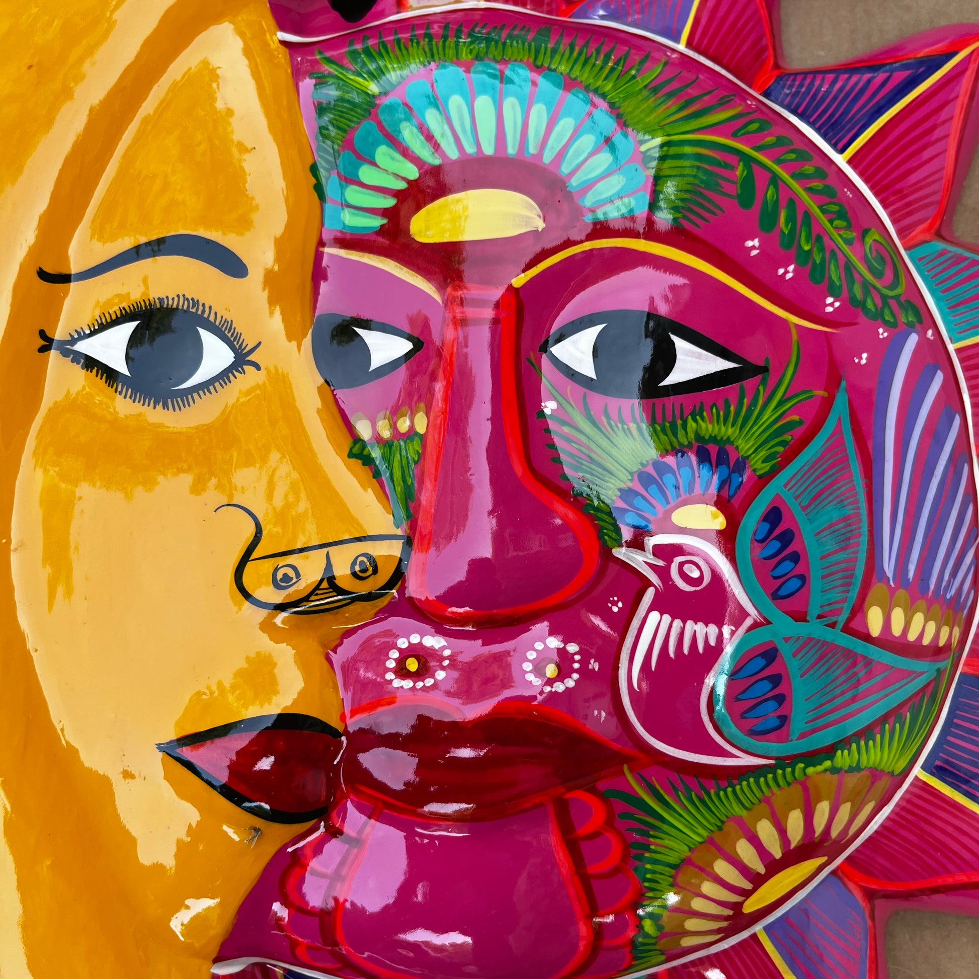 Folk art sun and moon eclipse close up faces 