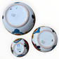 A set of three nested Talavera ceramic bowls with a vibrant hand-painted floral and geometric pattern in multiple colors, featuring a deep blue rim, shown on a plain white background, bottom view.