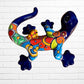 Colorful ceramic lizard wall art against a white brick wall background left side