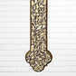 Decorative Milagros wood cross with many charms “miracles” on a white brick wall background Bottom half
