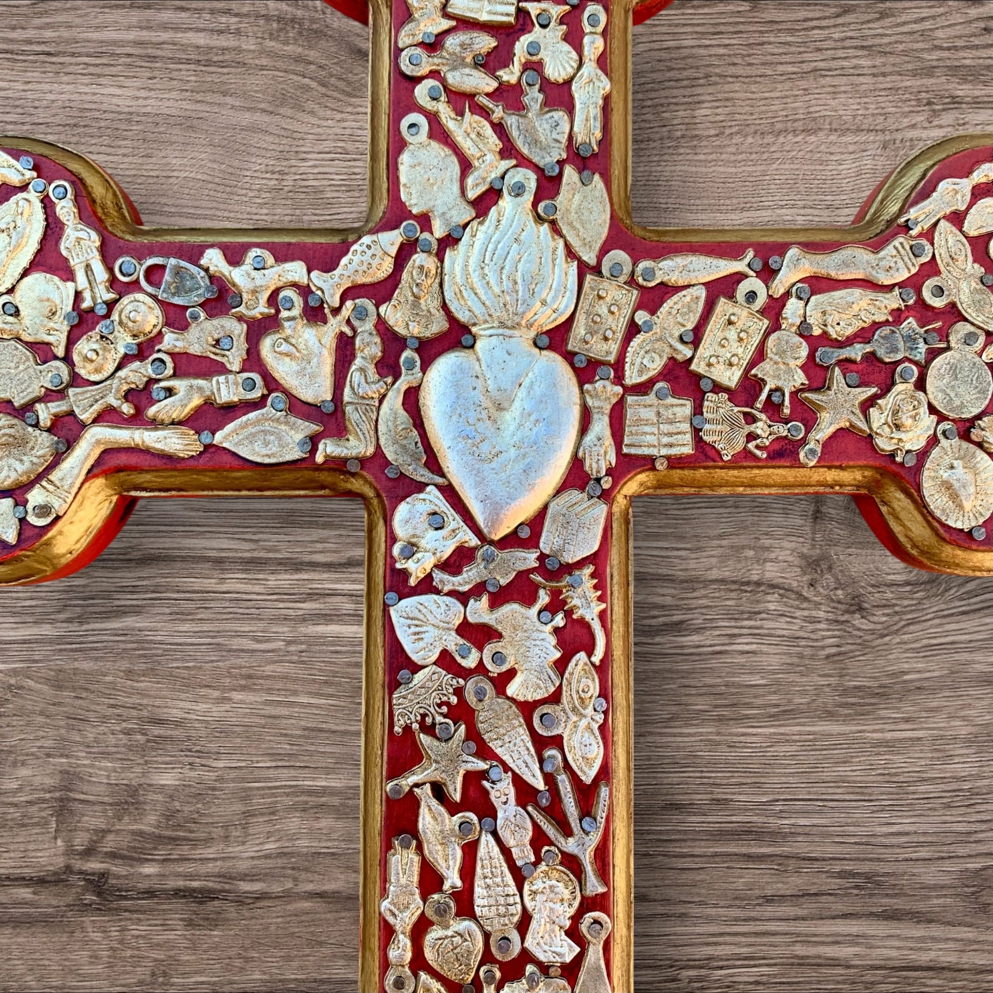 Milagros decorated wood cross center flaming heart