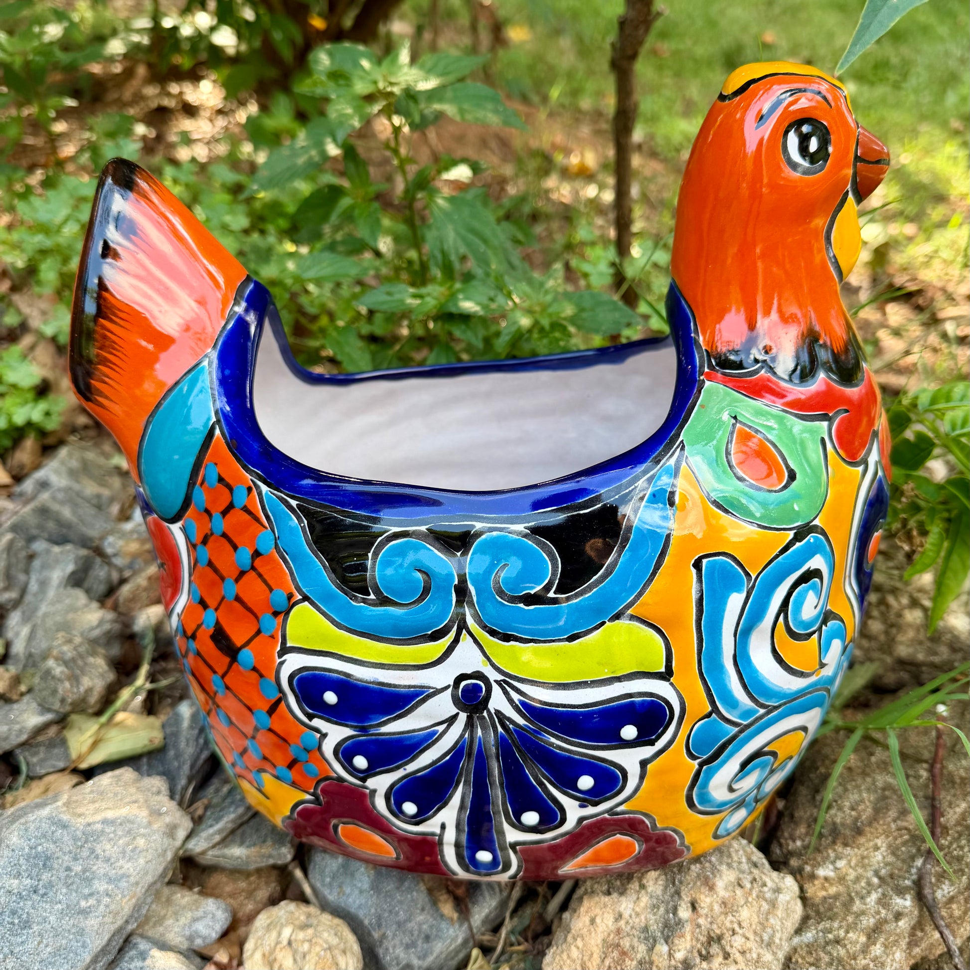 Colorful orange multi-color Mexican Talavera ceramic chicken shape planter on a natural background Right side 